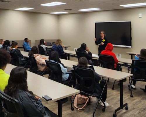  Heather Walker-Clarke stands talking to a group of students